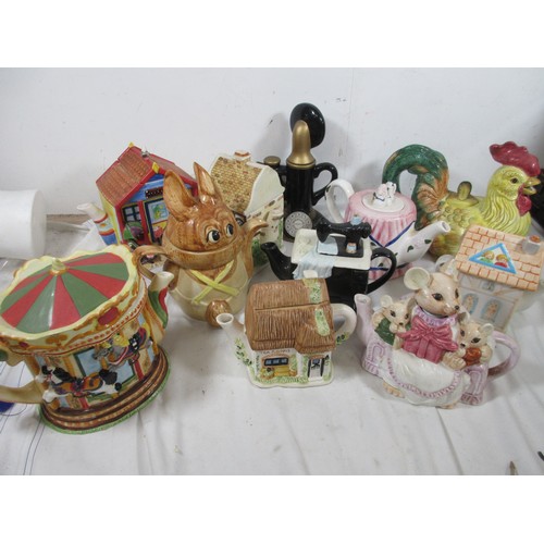 27 - A selection of Novelty teapots including a Cockrell all as per pictures
