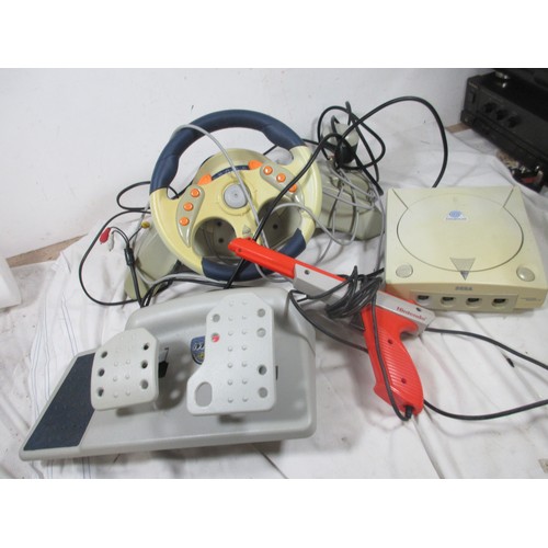 57 - A Sega Dreamcast Set up to include foot pedals ,Steering wheel ,Disc holder and a separate Gun ,may ... 