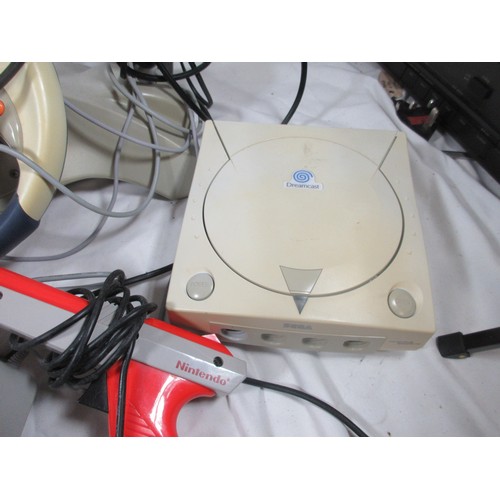 57 - A Sega Dreamcast Set up to include foot pedals ,Steering wheel ,Disc holder and a separate Gun ,may ... 