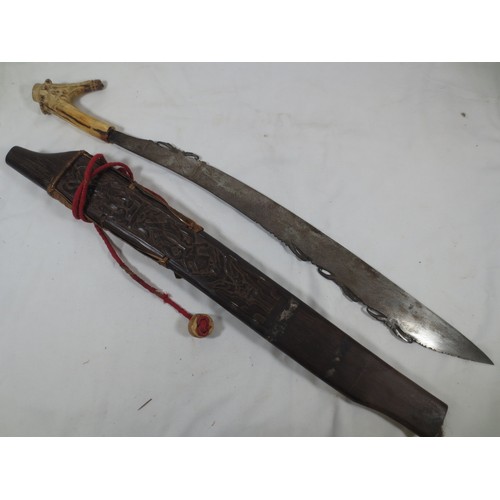 An antique hunter's parang with bone handle from North Borneo, in solid ...