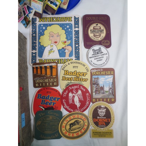 17 - Beer mats and matchbox covers, the contents of a box file and a sweets tub.  Approx. 110 beer mats, ... 