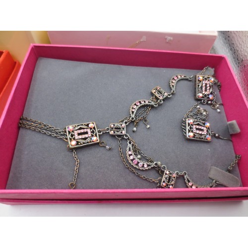 25 - A white plastic box with assorted costume jewellery,  and three boxed items of costume jewellery