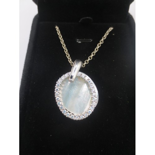 32 - A 925 silver necklace with a 925 silver, cubic zirconia and mother of pearl oval pendant.  With a bl... 
