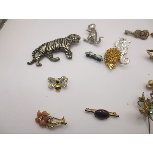 34 - Fifteen costume brooches, of which several are of animal theme