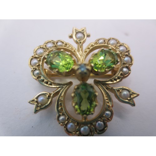11 - A 9 carat gold trefoil pendant brooch set with green stones (probably citrine) and seed pearls, with... 