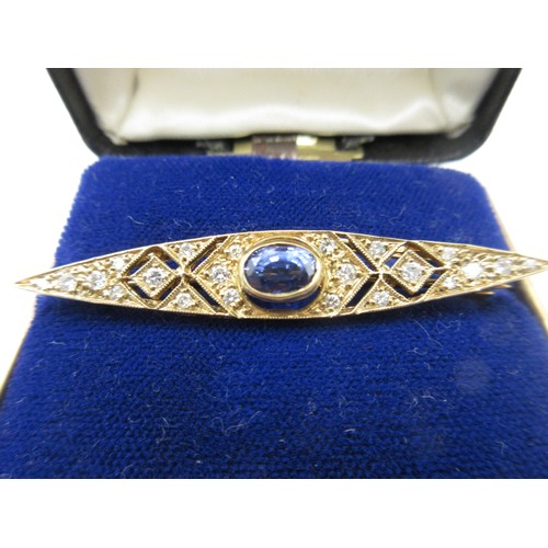 1 - A 9 carat gold brooch set with a central sapphire and twenty-two graduated brilliant cut diamonds.  ... 