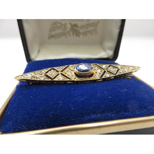 1 - A 9 carat gold brooch set with a central sapphire and twenty-two graduated brilliant cut diamonds.  ... 