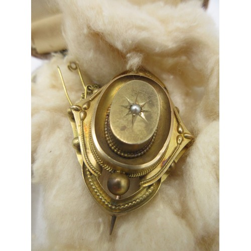 17 - An Edwardian gold memorial brooch,  tests positive for 12 carat gold,  of lobed oval shape with glaz... 