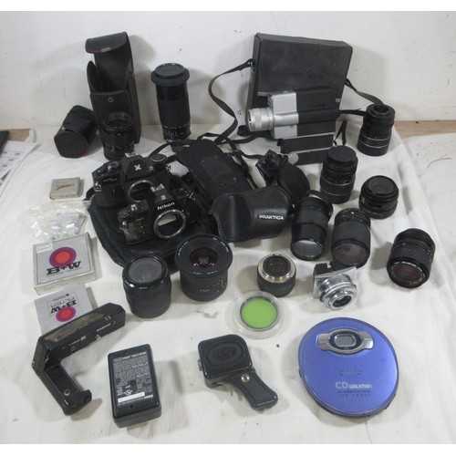 134 - A vintage suitcase full of vintage photographic equipment including camera bodies, lenses etc