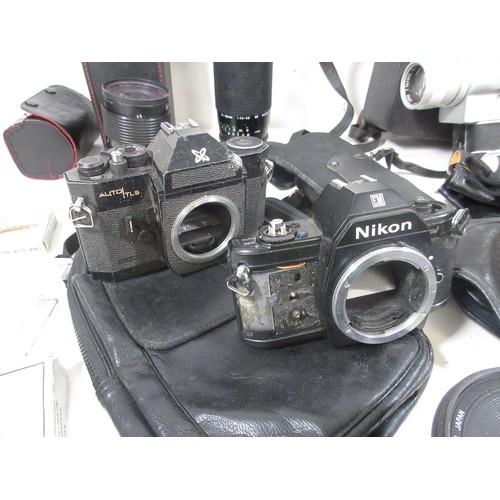 134 - A vintage suitcase full of vintage photographic equipment including camera bodies, lenses etc