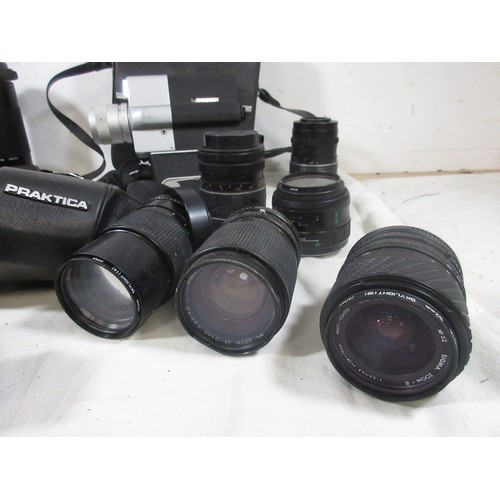 134 - A vintage suitcase full of vintage photographic equipment including camera bodies, lenses etc