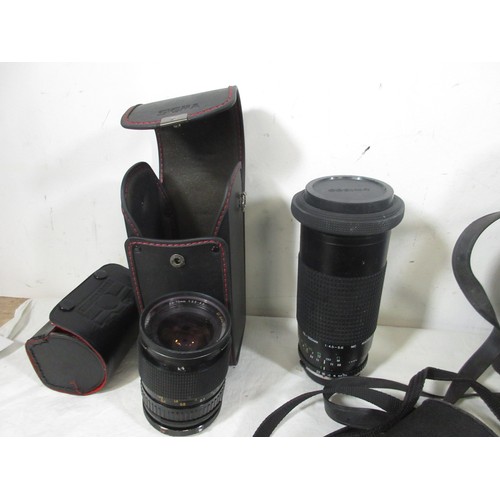 134 - A vintage suitcase full of vintage photographic equipment including camera bodies, lenses etc