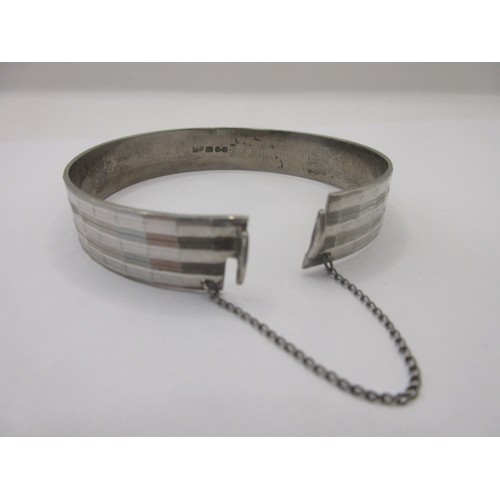 156 - A solid sterling silver bracelet with safety chain, hallmarked for London 1975 by Maylin, approx wei... 