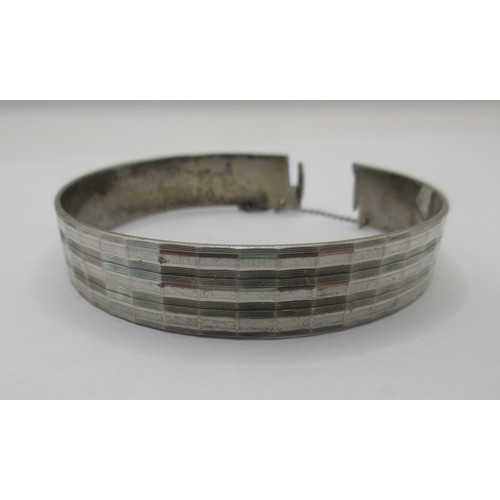 156 - A solid sterling silver bracelet with safety chain, hallmarked for London 1975 by Maylin, approx wei... 