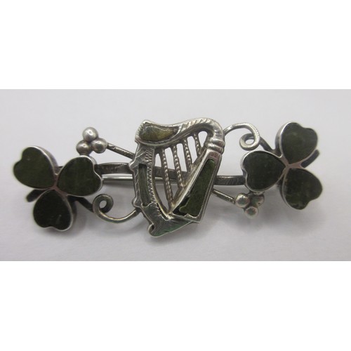 157 - A sterling silver brooch with an Irish theme with a central harp of Erin flanked by shamrocks, the w... 