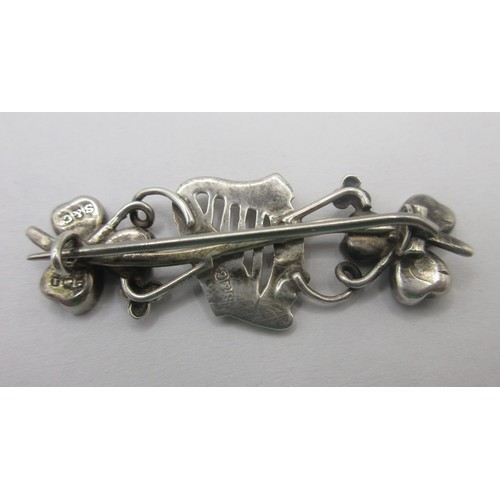 157 - A sterling silver brooch with an Irish theme with a central harp of Erin flanked by shamrocks, the w... 