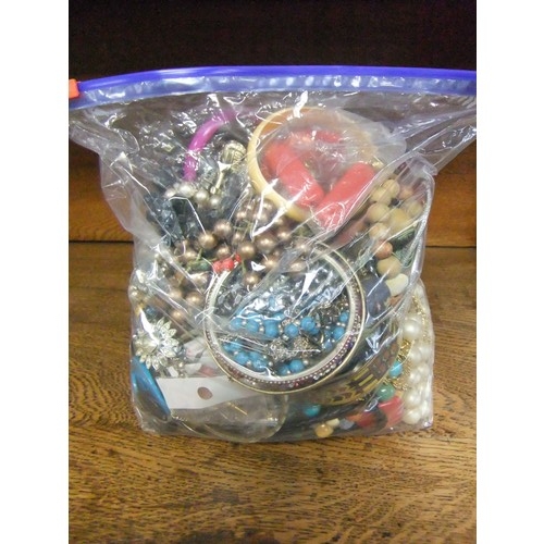 160 - A large bag of mixed costume jewellery