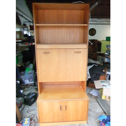 177 - A large G-Plan wall unit with drop front, mirrored with glass shelf and designed as a drink cabinet,... 