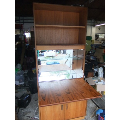 177 - A large G-Plan wall unit with drop front, mirrored with glass shelf and designed as a drink cabinet,... 