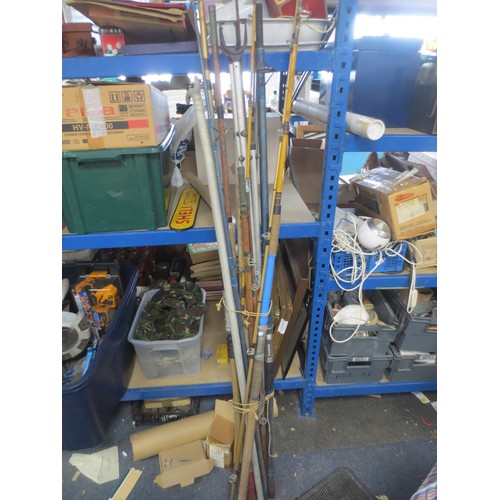 175 - A large bundle of vintage fishing rods, rod rests etc