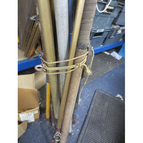 175 - A large bundle of vintage fishing rods, rod rests etc