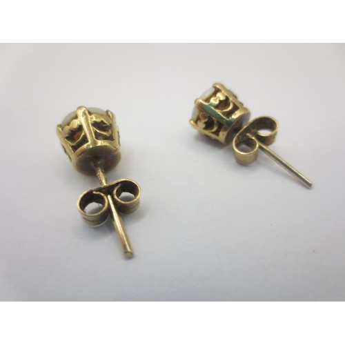 125 - A pair of 9 carat gold opal earrings,  combined approx. 2.5g,  British hallmarks to shafts, the butt... 