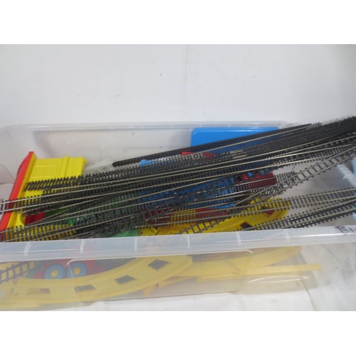 235 - Plastic tub full of toy trains and railways including some Hornby track, some of which is slight af
