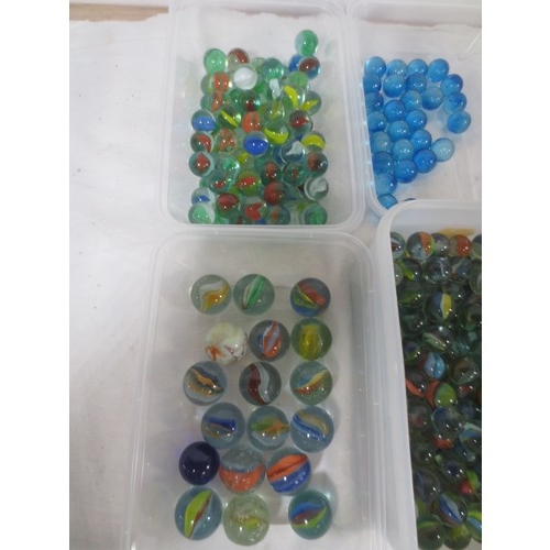 64 - A collection of glass marbles, including cats eye, swirled, blue, etc,  the contents of six plastic ... 