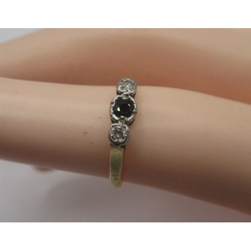 116 - An 18 carat gold sapphire and diamond ring.  A small central sapphire with two diamonds, ring size J... 