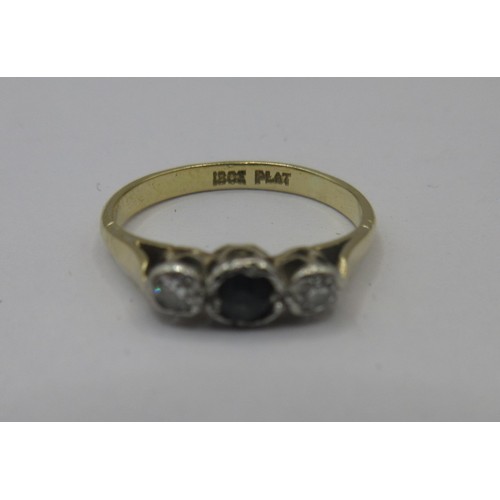 116 - An 18 carat gold sapphire and diamond ring.  A small central sapphire with two diamonds, ring size J... 