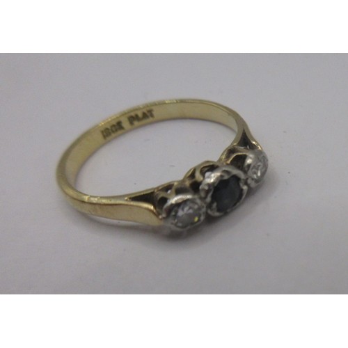 116 - An 18 carat gold sapphire and diamond ring.  A small central sapphire with two diamonds, ring size J... 