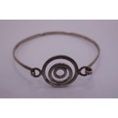 74 - A silver bangle with a looped clasp, marks for  London, 2006, indistinct maker's stamp