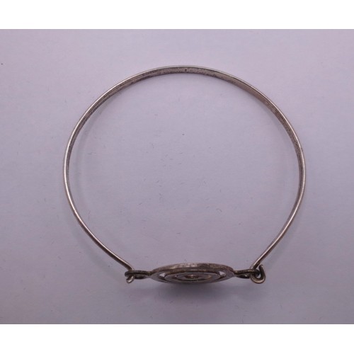 74 - A silver bangle with a looped clasp, marks for  London, 2006, indistinct maker's stamp