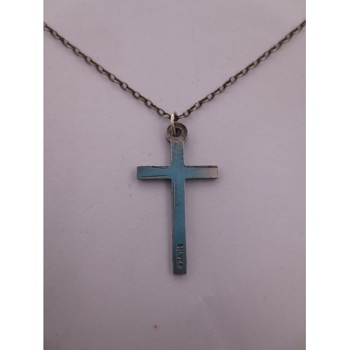 75 - A silver chain and cross pendant,  the clasp stamped sterling, the pendant stamped silver