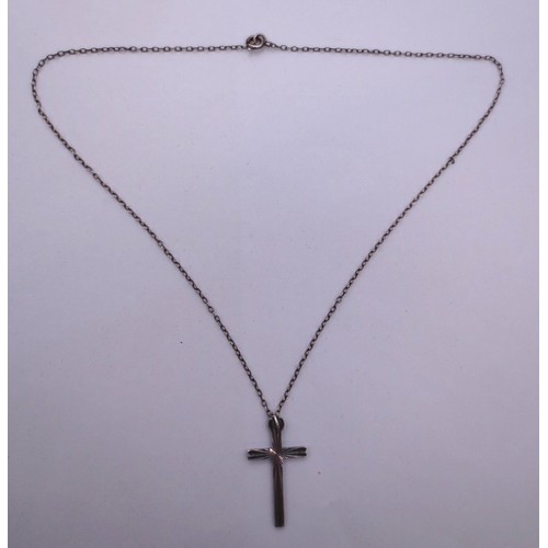 75 - A silver chain and cross pendant,  the clasp stamped sterling, the pendant stamped silver