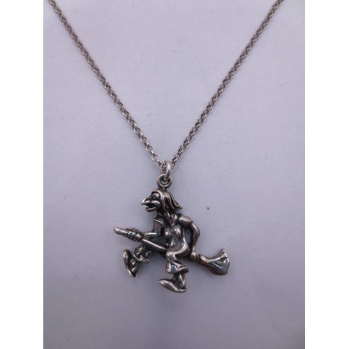 78 - A 925 silver chain with a white metal witch on broomstick pendant