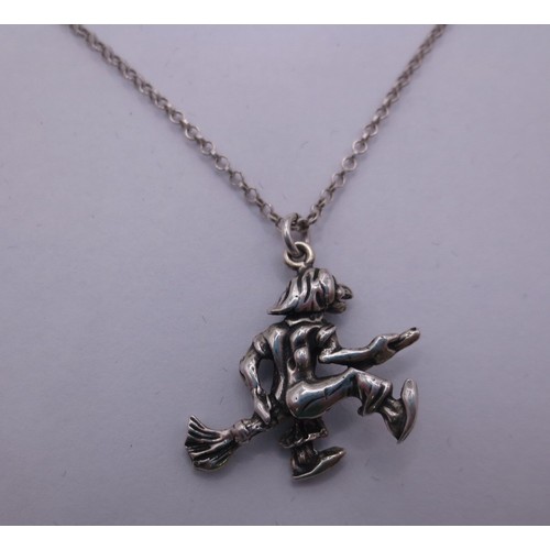 78 - A 925 silver chain with a white metal witch on broomstick pendant