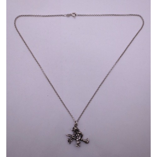 78 - A 925 silver chain with a white metal witch on broomstick pendant