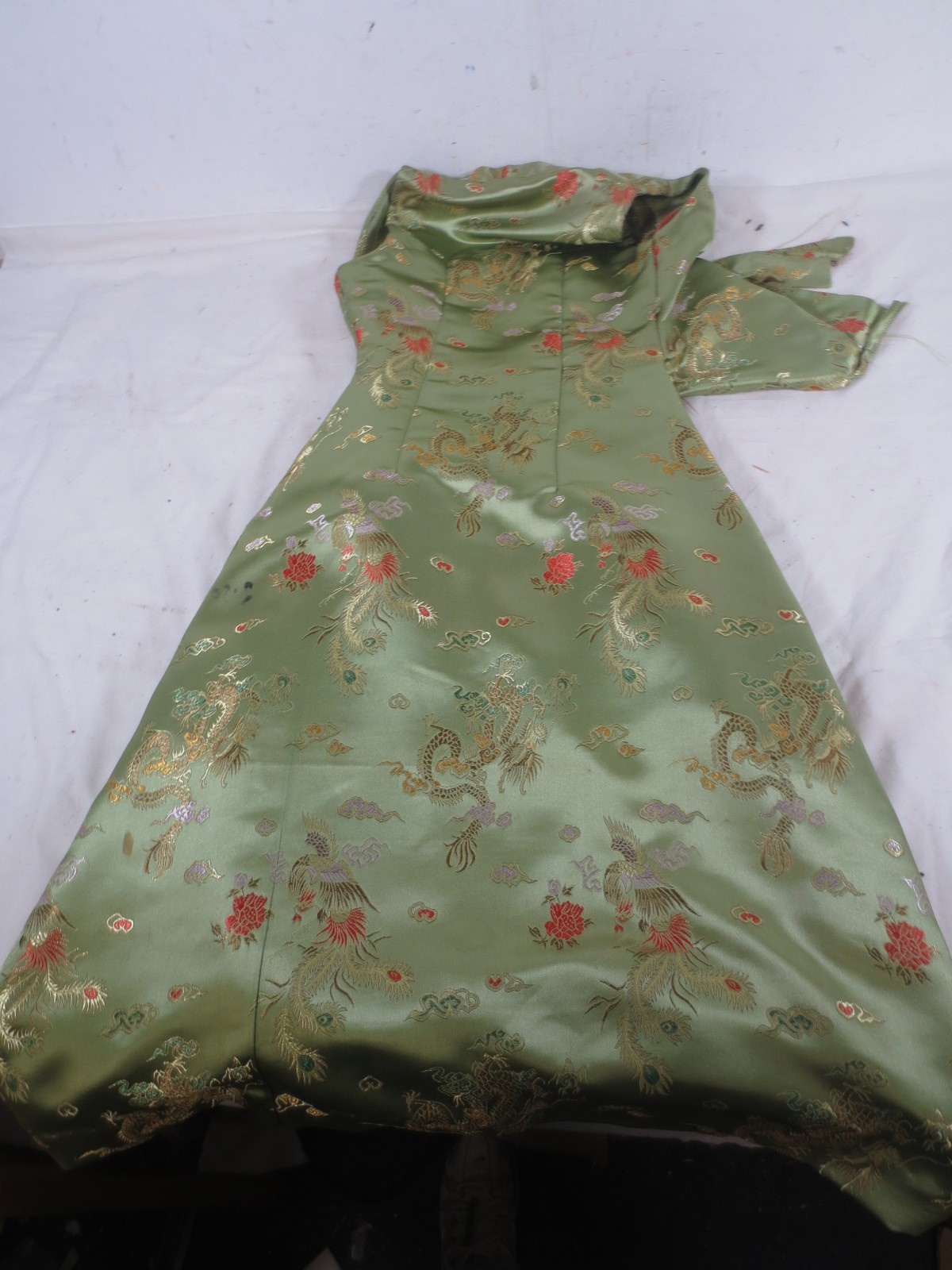 A green silk embroidered dress of Oriental design