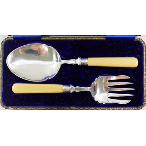 106 - A George V silver and ivorine handled serving spoon and fork, Sheffield 1912, with engraved decorati... 