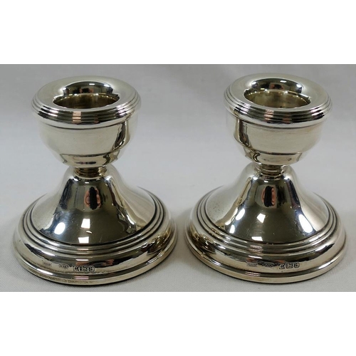 134 - A pair of squat silver candlesticks, Birmingham 1979, 5.7cm high, with loaded bases