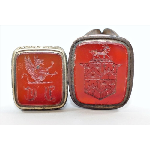 175 - Two 19th century seals, set with carnelian and carved with a coat of arms and crest, and a hexagonal... 