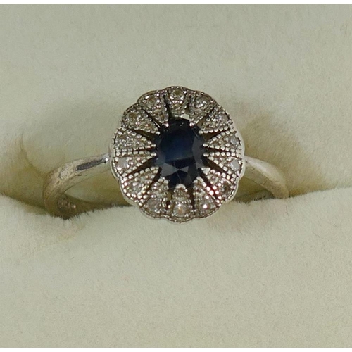 182 - A sapphire and diamond oval cluster ring, the shank stamped '925', finger size O 1/2, and a silver s... 