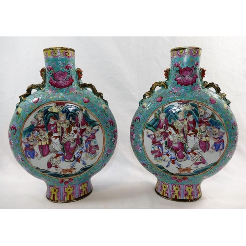 48 - A pair of Chinese famille rose porcelain moon flasks, with Tongzhi mark, decorated with figural pane... 