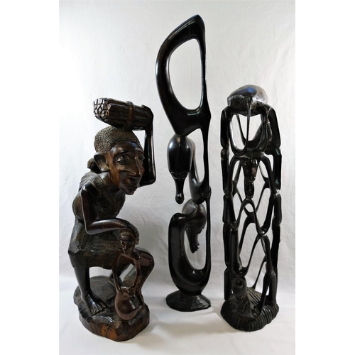 54 - A collection of nine African carvings and sculptures including a pair of masks and a wooden club, 50... 