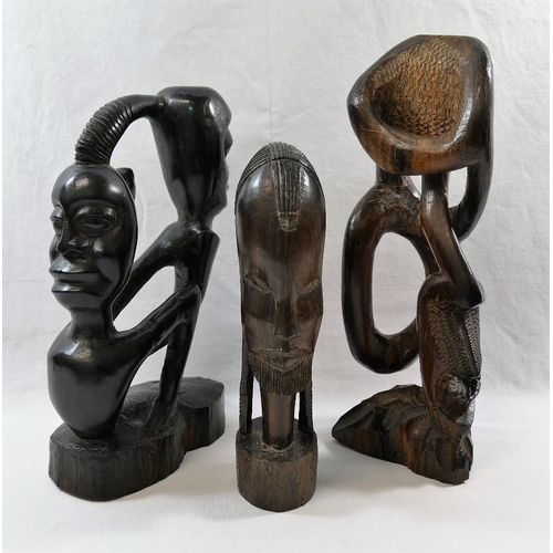 54 - A collection of nine African carvings and sculptures including a pair of masks and a wooden club, 50... 