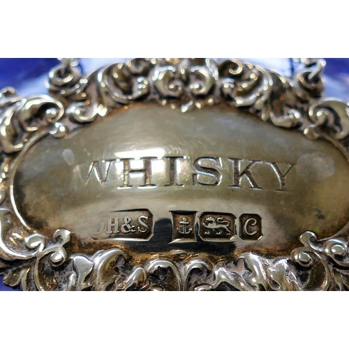 85 - A silver 'Whisky' decanter label, Birmingham 1977, 6.3cm wide, and a cut glass decanter, 27cm high