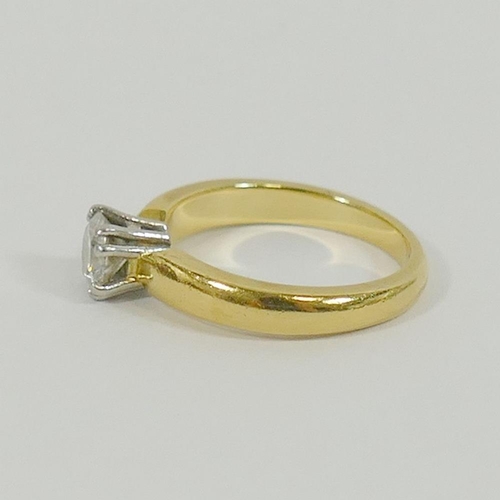 130 - An 18 carat gold and platinum diamond single stone ring, the round brilliant cut diamond approximate... 