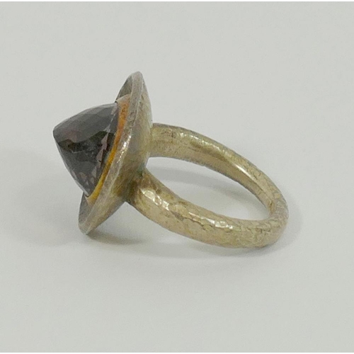 131 - A modern smokey quartz single stone ring by Poppy Dandiya, the silver coloured metal mount and shank... 