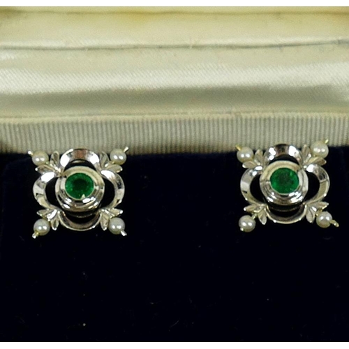 135 - A pair of 18 carat white gold emerald and seed pearl earrings by Cassandra Goad, the round mixed cut... 